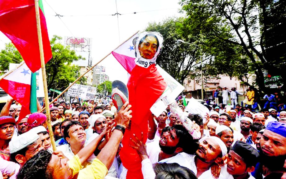 A man beats an effigy depicting Myanmar State Counsellor Aung San Suu Kyi with a slipper during a protest rally against what they say are killings of Rohingya people in Myanmar, in Kolkata, India.