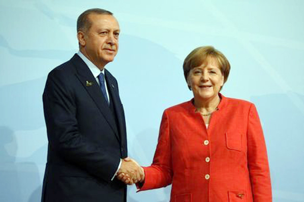 German Chancellor Angela Merkel greets Turkey's President Recep Tayyip Erdogan at the beginning of the G20 summit in Hamburg, Germany.