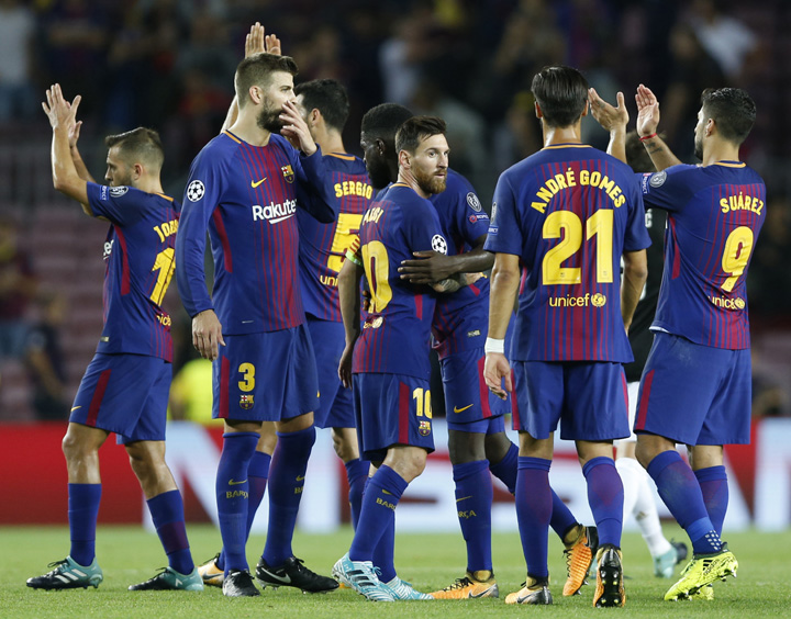 Barcelona players with Lionel Messi (center) celebrate after their 3-0 win during a Champions League group D soccer match between FC Barcelona and Juventus at the Camp Nou stadium in Barcelona, Spain on Tuesday.
