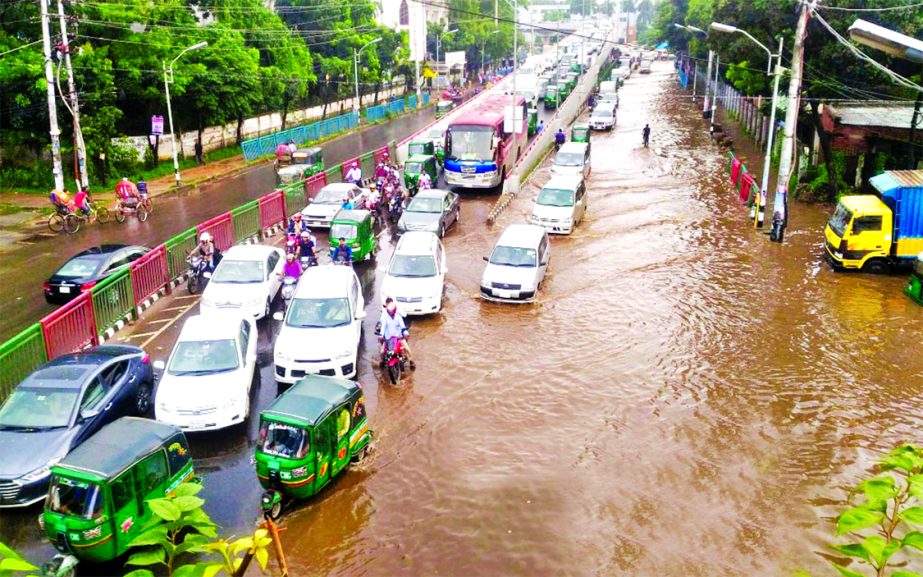 Heavy rains crippled city life as most of the roads went under ankle to knee-deep water, causing immense sufferings to the commuters due to inadequate storm-water drainage system. This photo was taken from the city's Tejgaon area on Wednesday afternoon.