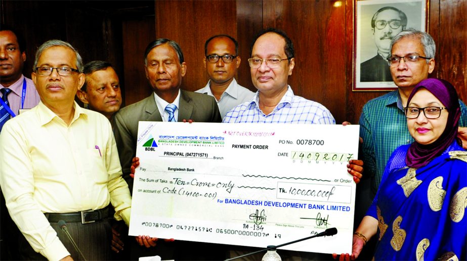 Md. Yeasin Ali, Chairman, Board of Directors of Bangladesh Development Bank Limited, handing over a cheque of cash dividend Tk10 crore for the year 2016 to Finance Secretary Hedayetullah Al Mamoon on Thursday at Secretariat. Senior Secretary of Financial