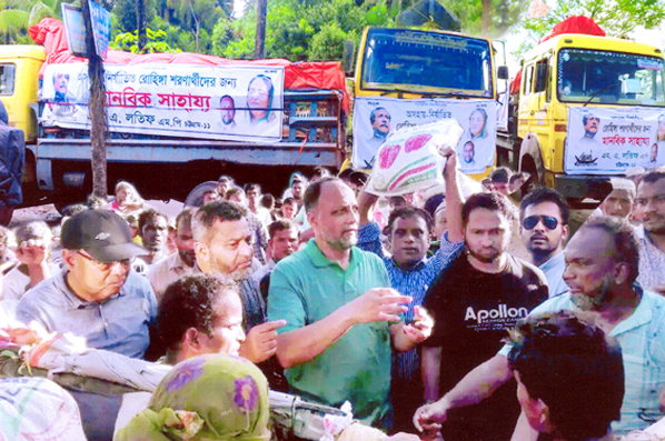 M A Latif MP distributing relief money among the Rohingyas in Teknaf recently.