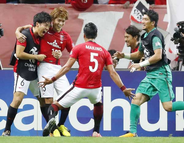 Urawa Reds' Toshiyuki Takagi (second from left) celebrates after scoring a goal against Kawasaki Frontale during their quarterfinal match of the Asian Champions League in Saitama on Wednesday. Urawa Reds defeated Kawasaki Frontale 4-1 to reach the ACL