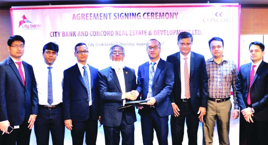 Mashrur Arefin, AMD of City Bank Limited and Shah Kamaluddin, Director of Concord Real Estate and Development Limited, exchanging an agreement signing documents at the bank head office in the city recently. Under the deal, customers of the developer compa