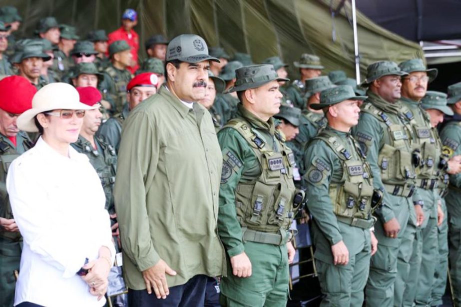 Venezuela's President Nicolas Maduro (2nd L) attends a military parade, as he is flanked by his wife Cilia Flores (L) and Venezuela's Defense Minister Vladimir Padrino Lopez in Maracay on Tuesday.