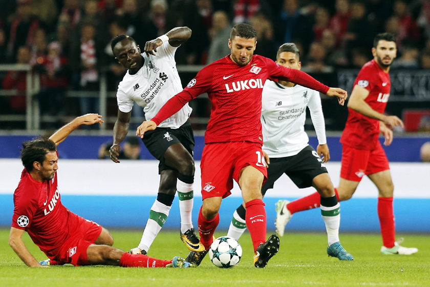 Spartak's Salvatore Bocchetti (center), Spartak's Ivelin Popov (bottom left) and Liverpool's Sadio Mane challenge for the ball during the Champions League soccer match between Spartak Moscow and Liverpool in Moscow, Russia on Tuesday.