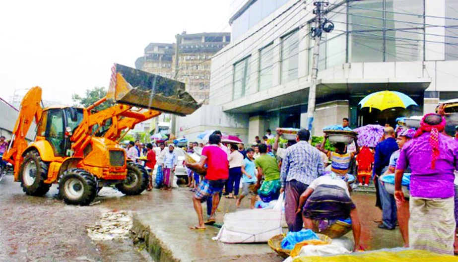 Dhaka North City Corporation authority evicting the illegal structures on footpaths in city's Karwan Bazar area on Wednesday.