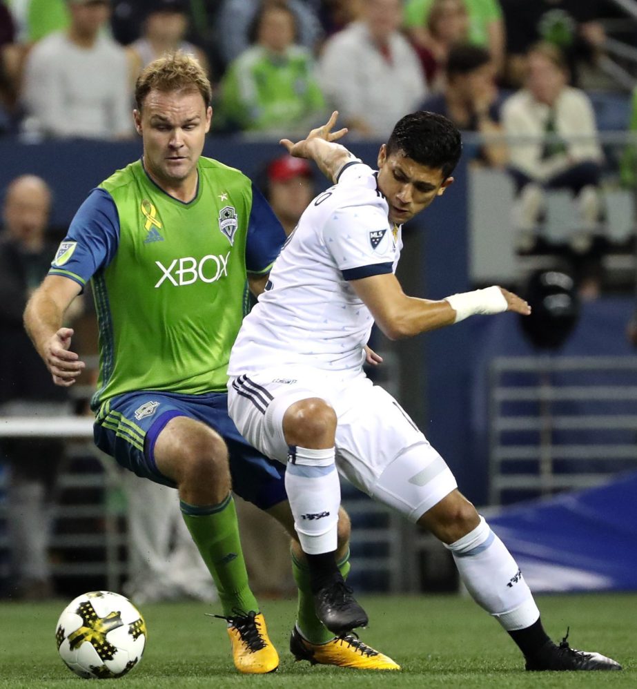 Seattle Sounders' Chad Marshall guards Vancouver Whitecaps' Fredy Montero (right) during the first half of an MLS soccer match in Seattle on Wednesday.