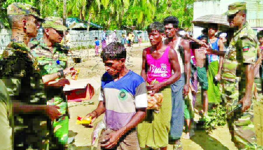 Rohingya refugees being given relief under the supervision of Armed Forces. This photo was taken on Thursday. ISPR photo