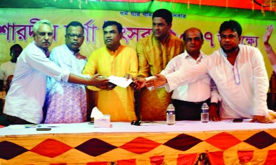 BETAGI (Barguna): Finance Secretary of Bangladesh Awami Jubo League Subash Chandra Howlader giving donation to different Puja mandaps at Betagi Upazila yesterday