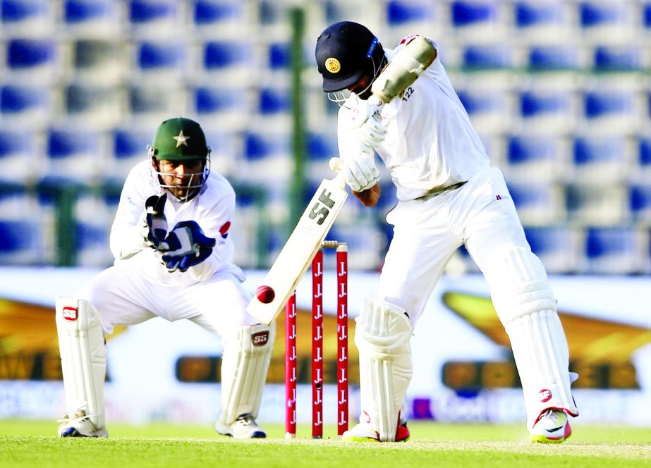 Sri Lanka's batsman Dinesh Chandimal plays a shot against Pakistan during their second day of the first Test cricket match in Abu Dhabi, United Arab Emirates on Friday.