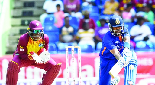 Suryakumar Yadav (right) of India hits 4 and Devon Thomas (left) of West Indies watches during the 3rd T20I match between West Indies and India at Warner Park, Basseterre, Saint Kitts and Nevis on Tuesday.