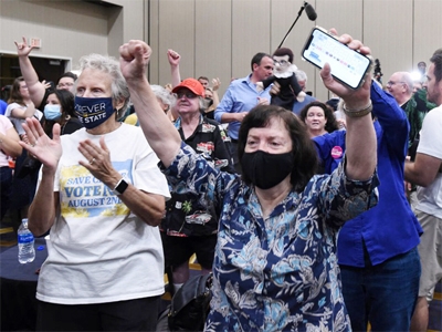 Pro-abortion rights supporters cheer as voting results show Kansas has voted to maintain the statewide right to abortion, in Overland Park, Kansas.