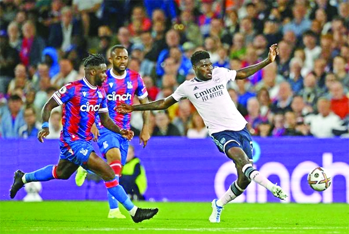 Arsenal's midfielder Thomas Partey (right) passes the ball during the English Premier League football match between Crystal Palace and Arsenal at Selhurst Park in south London on Friday.