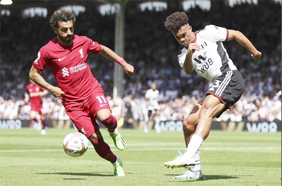 Liverpool's Mohamed Salah (left) and Fulham's Antonee Robinson vie for the ball during the English Premier League soccer match between Fulham and Liverpool at Craven Cottage stadium in London on Saturday.
