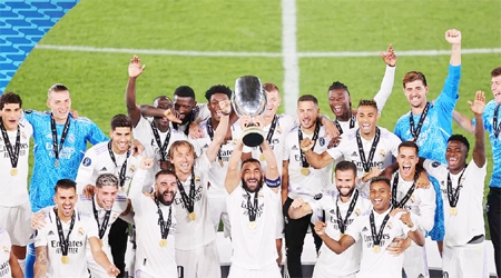 Real Madrid players celebrate with the trophy after winning the UEFA Super Cup final soccer match against Eintracht Frankfurt at Helsinki's Olympic Stadium, Finland on Wednesday.