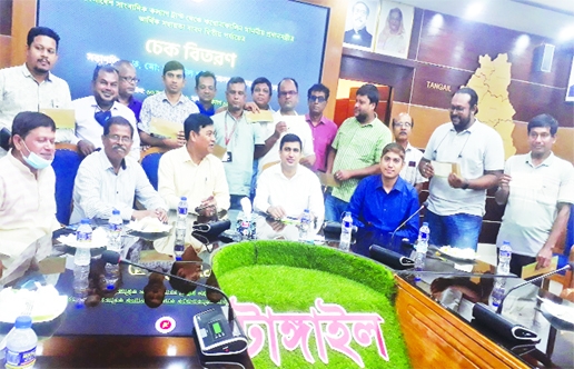 MIRZAPUR: Tangail District Commissioner is seen in a photo session with journalists working in Tangail's Mirzapur Upazila in a cheque distribution program on Friday.