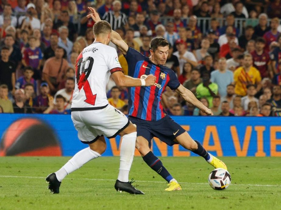 FC Barcelona's Robert Lewandowski (right) shoots at goal bar of Rayo Vallecano during the Spanish league football match at the Camp Nou stadium in Barcelona on Saturday. Agency photo