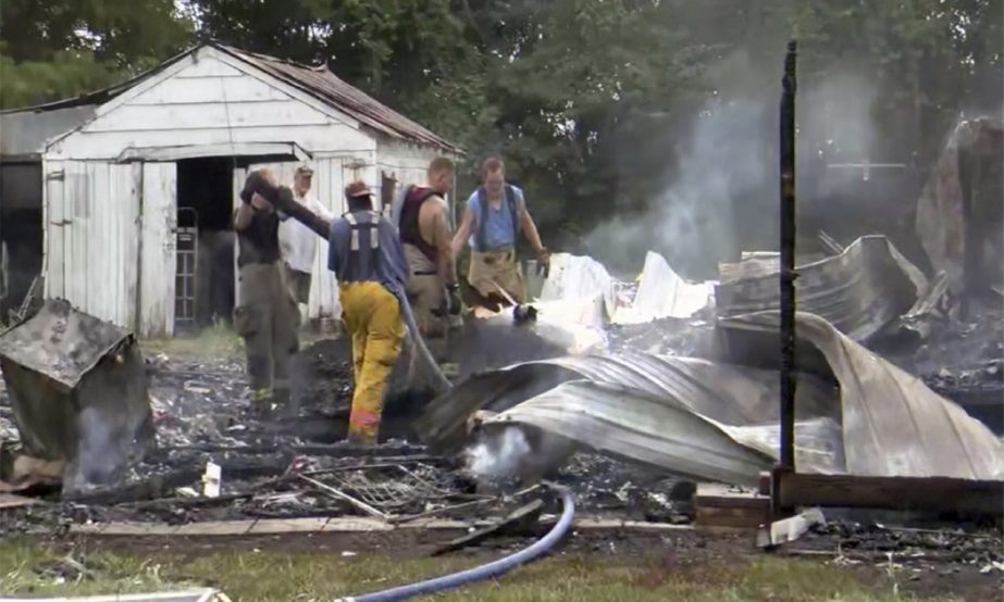 This photo from video by KFVS-TV shows people working the scene of a house explosion in Wyatt Mo., early Monday, Aug. 15, 2022.