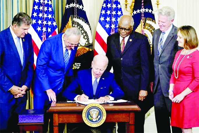 President Joe Biden signs the Democrats' landmark climate change and health care bill in the State Dining Room of the White House in Washington on Tuesday.