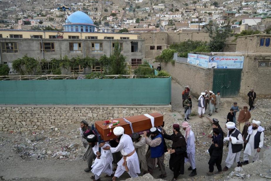 Mourners carry the body of a victim of a mosque bombing in Kabul, Afghanistan, Thursday, Aug. 18. 2022.