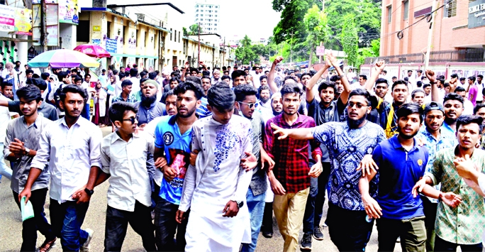 Students of Tejgaon Polytechnic Institute stage a protest rally blocking the road in front of the institute on Monday for cancellation of admission into a three-year-long diploma course.