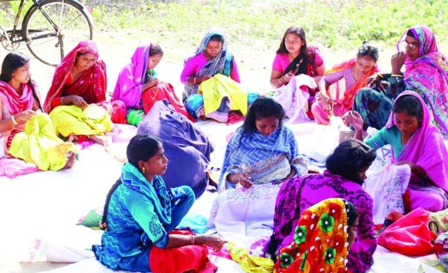 ISHWARDI (Pabna) : Women of Ethnic community in Ishwardi Upazila are engaged in kantha stitching. The picture was taken from Marmi village on Tuesday. NN photo