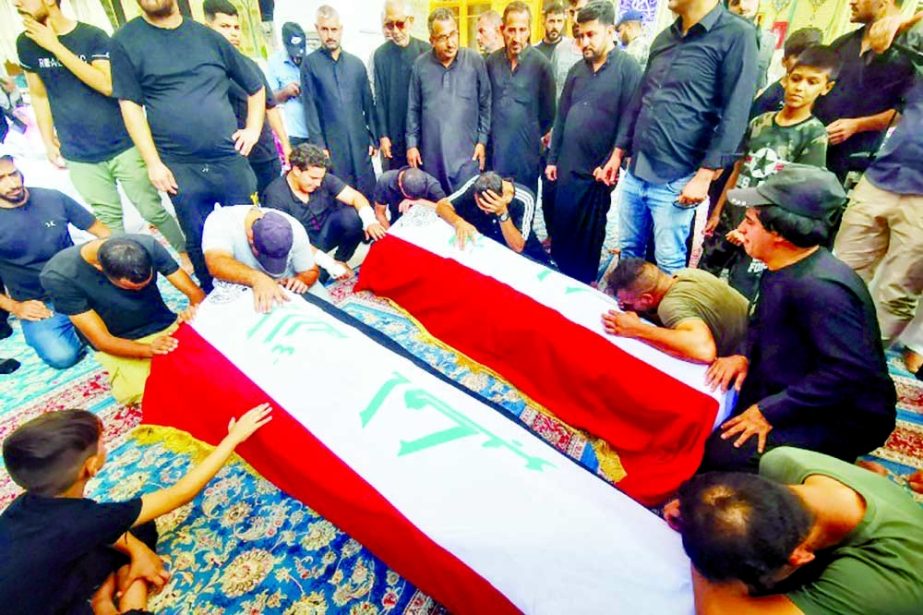 Mourners pray in front of the coffins of supporters of Iraqi populist leader Muqtada al-Sadr, who were killed in clashes in Baghdad, during their funeral in Najaf, Iraq on Tuesday. Agency photo