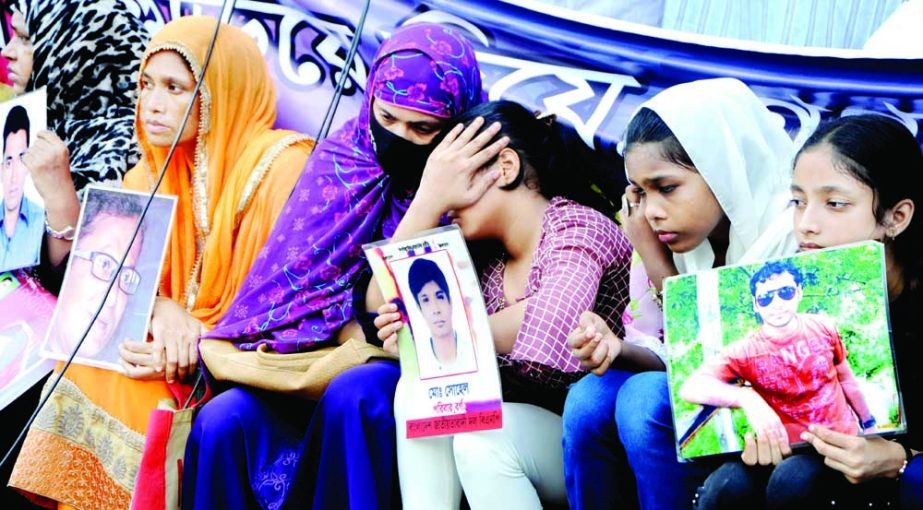 Children shed tears for their fathers during a demonstration in Dhaka's Shahbagh on Tuesday as families and friends of missing people demand the whereabouts of their loved ones marking the International Day of the Disappeared. NN photo