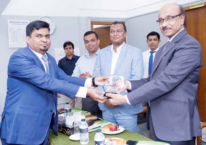 Banker Jasimuddin receiving honourary crest from Deputy Governor of Bangladesh Bank at the inauguration ceremony of Agri Credit Loan Project recently.