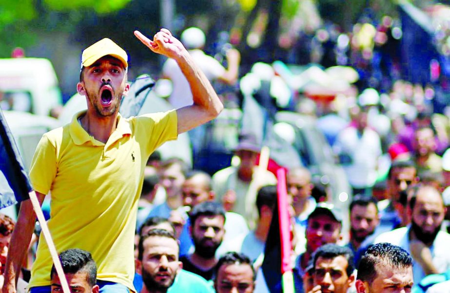 A Palestinian demonstrator gestures as he chants slogans during a protest against Bahrain's workshop for U.S. Middle East peace plan, in Gaza City.