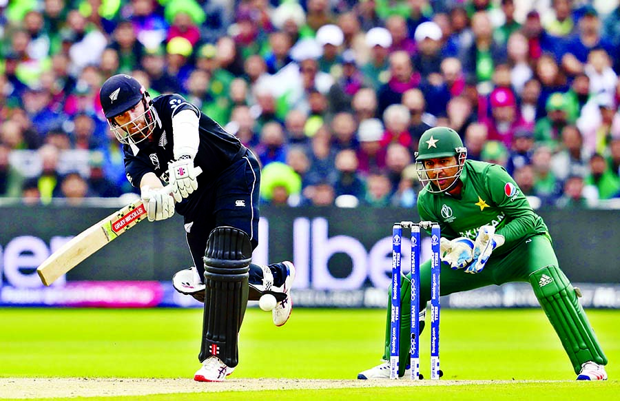 New Zealand's captain Kane Williamson (left) plays a shot as Pakistan's captain Sarfaraz Ahmed looks on during the ICC World Cup Cricket match between New Zealand and Pakistan at the Edgbaston Stadium in Birmingham on Wednesday. Kane Williamson hit a po