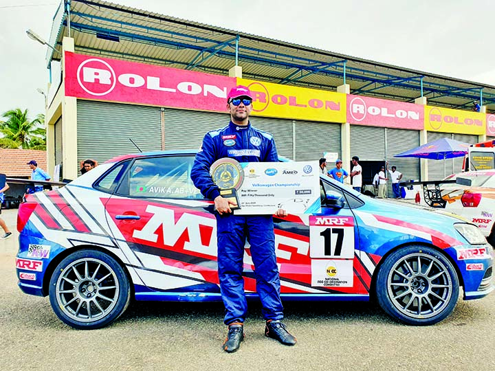 Avik Anwar with his prizes poses for a photograph in front of his racing car recently. Agency photo