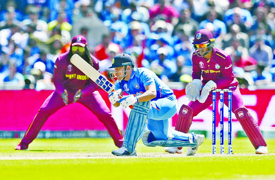 India's Mahendra Singh Dhoni bats during the ICC World Cup Cricket match between India and West Indies at Old Trafford in Manchester on Thursday.