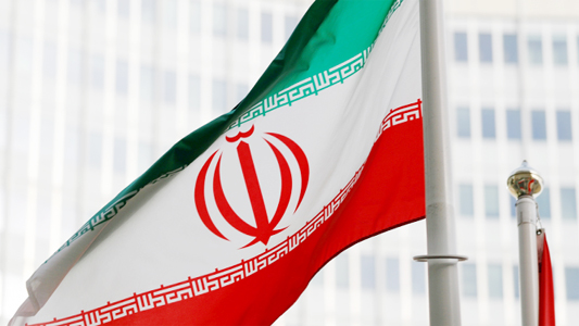 The Iranian flag flutters in front of the International Atomic Energy Agency (IAEA) headquarters in Vienna, Austria.