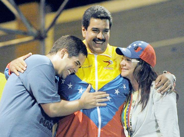 Venezuelan acting President Nicolas Maduro Â© embraces his wife Cilia Flores Â® and son Nicolas Maduro during a campaign rally-Maduro's son is now the target of US economic sanctions