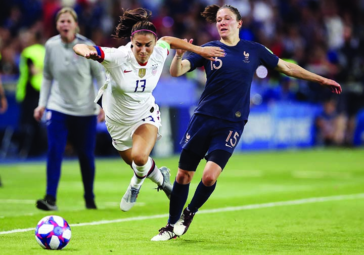 United States' Alex Morgan (left) competes for the ball against France's Elise Bussaglia during the Women's World Cup quarterfinal soccer match between France and the United States at the Parc des Princes in Paris on Friday.