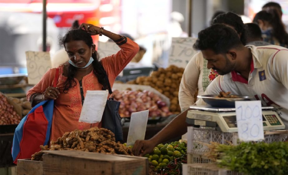 A woman bargains as she buys vegetables at a market place in Colombo, Sri Lanka, Friday, June 10, 2022. File photo