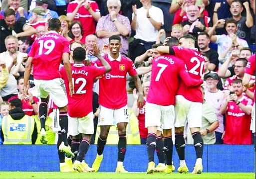 Manchester United's Marcus Rashford (center) celebrates after scoring his side's second goal during the English Premier League soccer match against Arsenal at Old Trafford stadium in Manchester, England on Sunday.