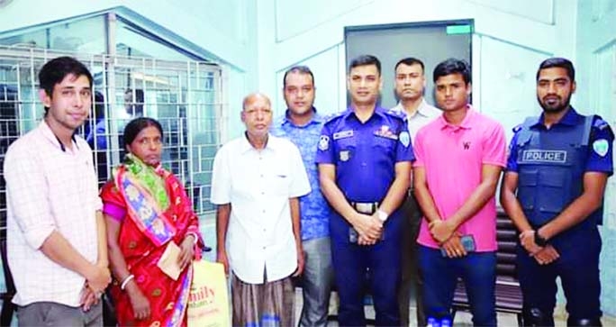 FENI: Feni District Superintendent of Police Zakir Hasan poses with missing Ashutosh after handed over him to his family on September 1.
