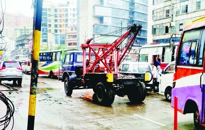 A police wrecker becomes out of order in the middle of the road in city's Kakrail area on Monday, causing traffic congestion on the busy road.