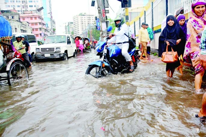 The Inner Circular Road at Fakirapool in Dhaka goes under water after a shower on Monday noon.