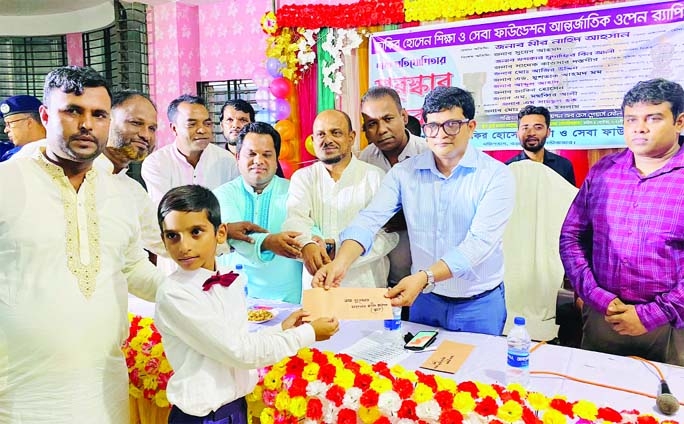 Deputy Commissioner of Moulvibazar district Mir Nahid Ahsan hands over a cash prize-money to a winner of the Rating Chess Competition at Barlekha upazila in Moulvibazar district recently.