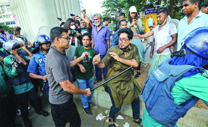 Police charge baton on a demonstrator who blocked Shahbagh intersection on Friday demanding age limit extension for job seekers.