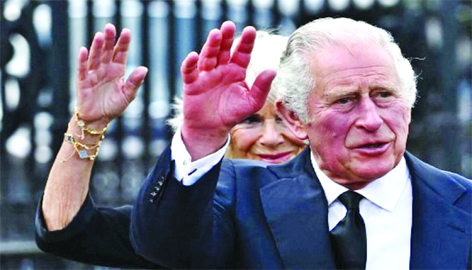 King Charles III and Camilla, Queen Consort, greet the crowd upon their arrival at Buckingham Palace in London, on Friday, a day after the death of Queen Elizabeth II.