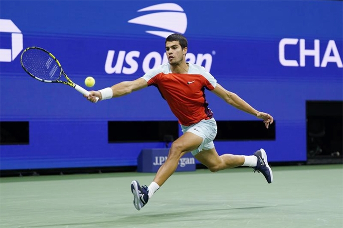 Carlos Alcaraz, of Spain, returns a shot to Frances Tiafoe, of the United States, during the semifinals of the US Open tennis championships in New York on Friday.