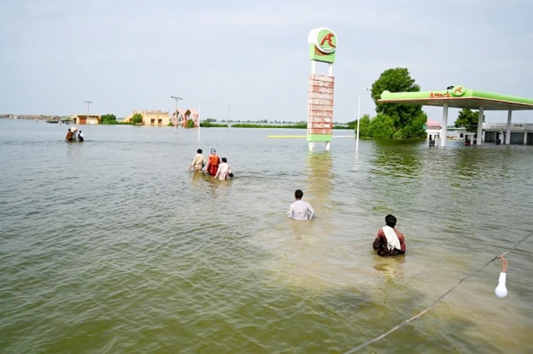 Unfortunate people are wading through waist-high water in search of their villages sunken in floods.