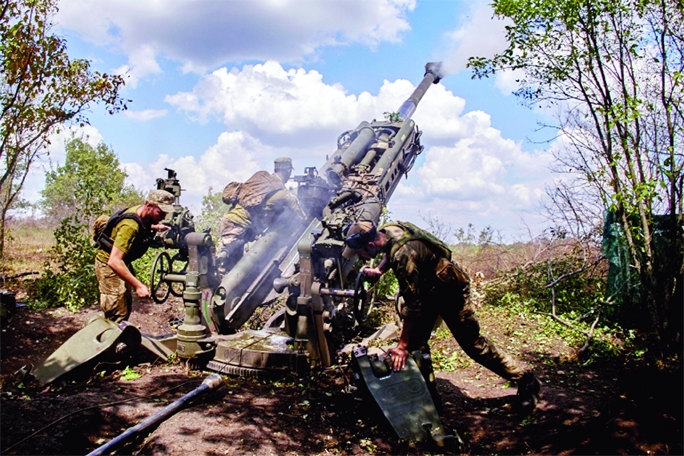 Ukrainian soldiers fire a US-made M777 howitzer from positions in the Kharkiv area on Saturday.