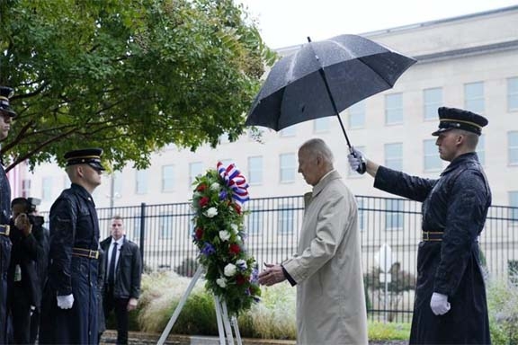 President Joe Biden participates in a wreath laying ceremony while visiting the Pentagon in Washington on Sunday to honor and remember the victims of the September 11th terror attack.