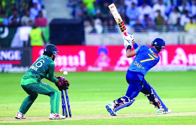 Sri Lanka's captain Dasun Shanaka (right) is bowled out by Pakistan's Shadab Khan (not in the picture) during the Asia Cup Twenty20 cricket final match against Pakistan at the Dubai International Cricket Stadium on Sunday.